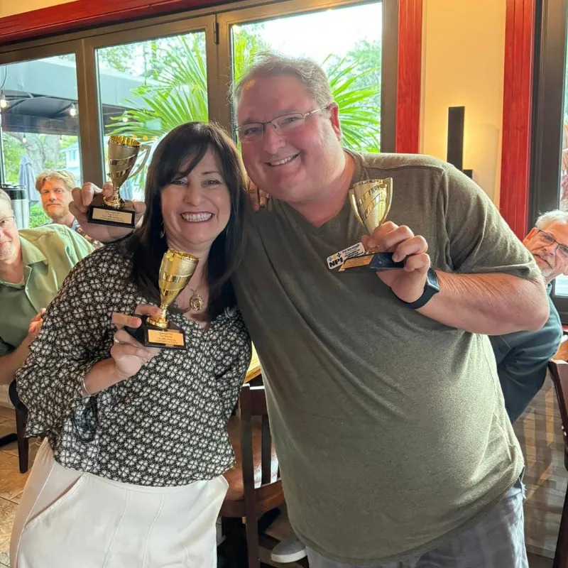 Suncoast NPI members celebrating referrals and business growth in a fun networking meeting.